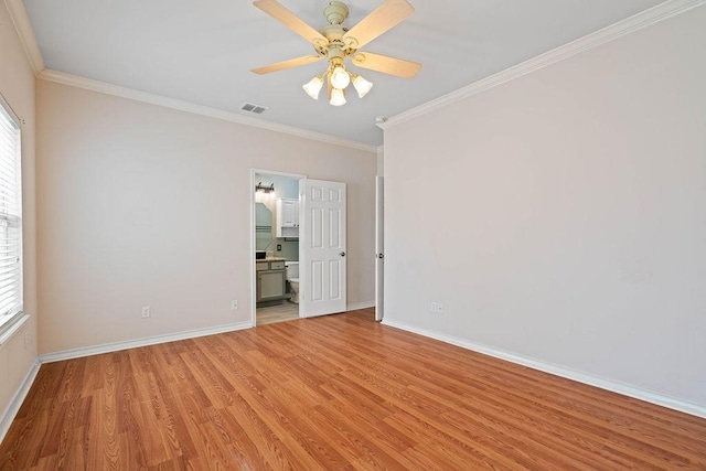 unfurnished room featuring visible vents, ornamental molding, a ceiling fan, light wood-style floors, and baseboards