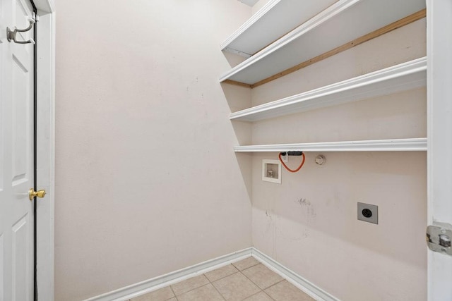 washroom featuring baseboards, washer hookup, laundry area, light tile patterned flooring, and electric dryer hookup