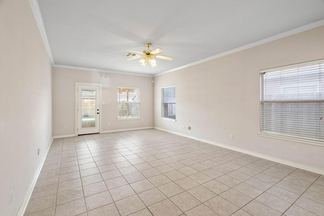 spare room with a ceiling fan, visible vents, baseboards, light tile patterned flooring, and crown molding