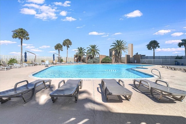pool featuring fence and a patio