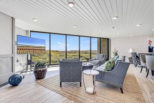 living area featuring recessed lighting, floor to ceiling windows, wooden ceiling, and light wood finished floors