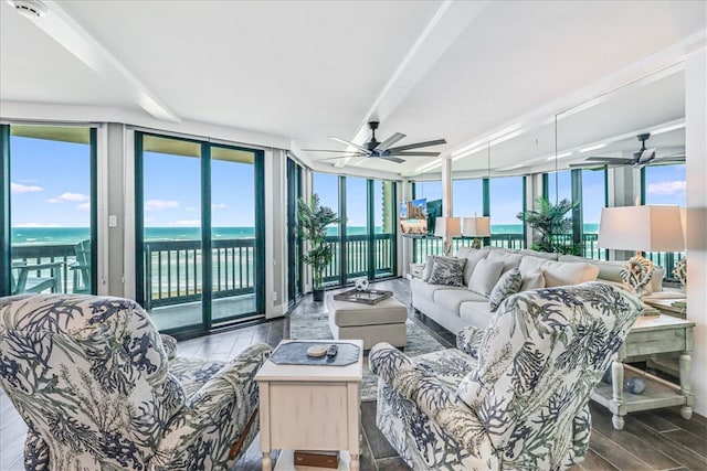 sunroom / solarium featuring a water view