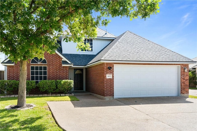 3837 Brockhampton Ct, Corpus Christi, TX 78414 - view of front of property featuring concrete driveway, brick siding, a garage, a shingled roof, and a front lawn