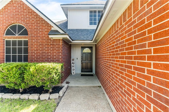 3837 Brockhampton Ct, Corpus Christi, TX 78414 - doorway to property featuring roof with shingles and brick siding
