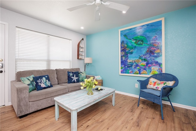 living room featuring ceiling fan and light hardwood / wood-style flooring