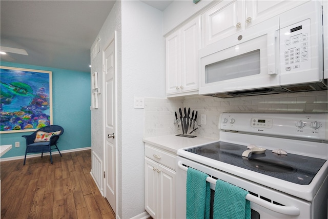 kitchen featuring white cabinets, decorative backsplash, dark hardwood / wood-style floors, and white appliances