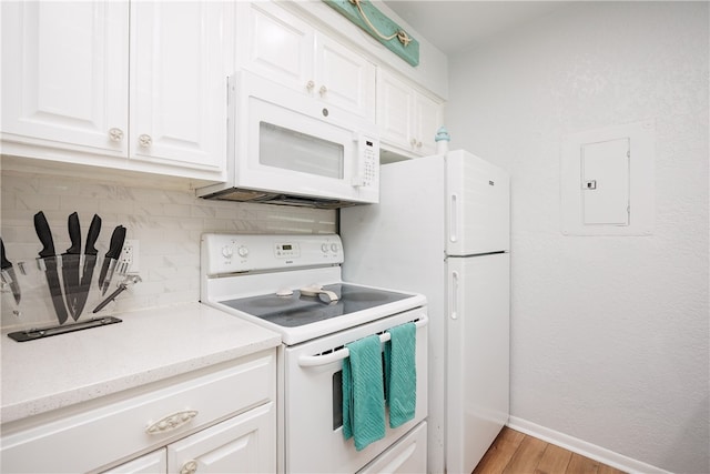 kitchen featuring light hardwood / wood-style floors, electric panel, backsplash, white appliances, and white cabinets