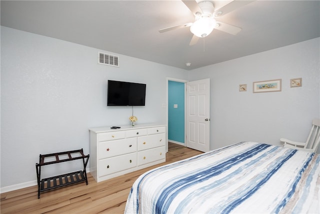 bedroom with light hardwood / wood-style floors and ceiling fan