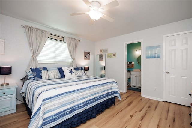 bedroom with ceiling fan, connected bathroom, and light wood-type flooring