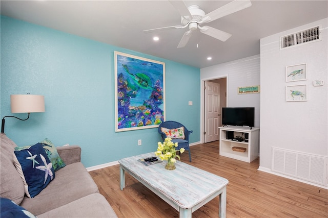 living room with ceiling fan and light hardwood / wood-style floors