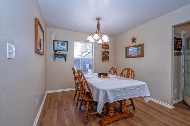 dining room featuring hardwood / wood-style floors and a notable chandelier