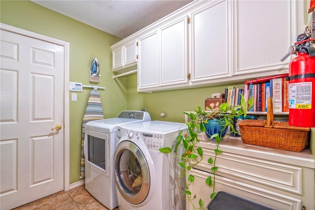 washroom featuring cabinets and washing machine and clothes dryer