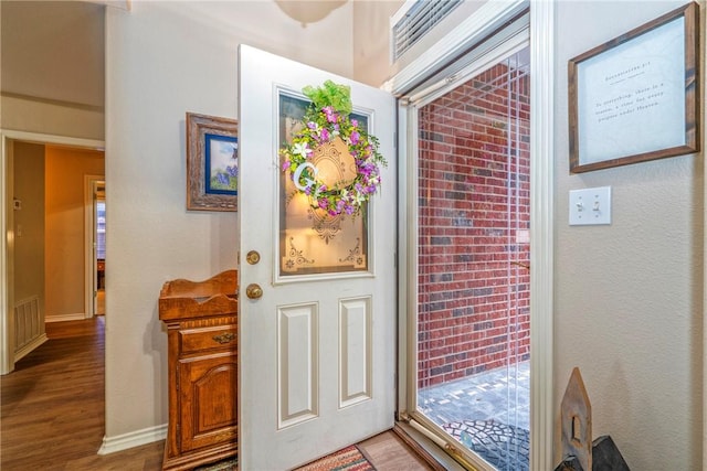 entryway with hardwood / wood-style floors