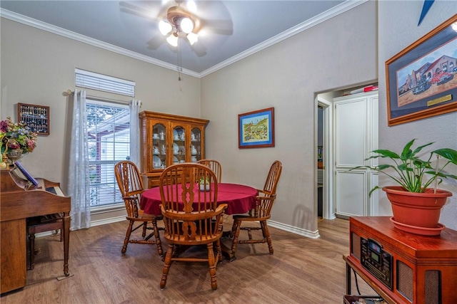 dining area with hardwood / wood-style flooring, ornamental molding, and ceiling fan