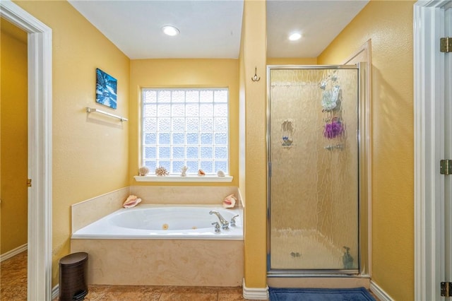 bathroom featuring shower with separate bathtub