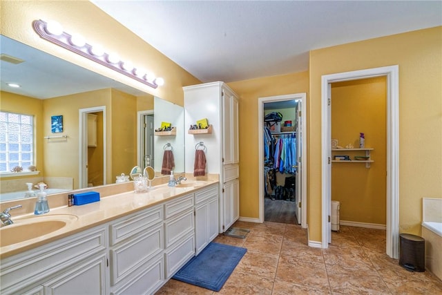 bathroom with vanity and a washtub