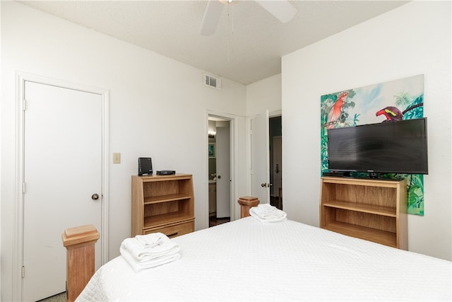 bedroom with a textured ceiling and ceiling fan