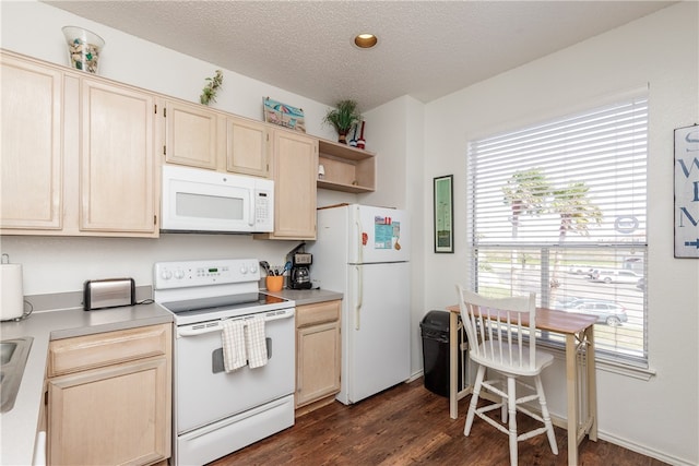 kitchen featuring a textured ceiling, dark wood-type flooring, light brown cabinetry, and white appliances