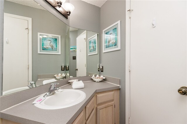 bathroom featuring vanity and a textured ceiling