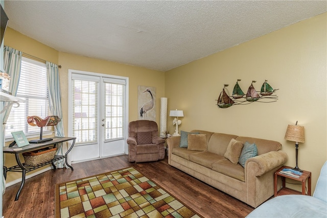 living room featuring a textured ceiling and dark hardwood / wood-style flooring