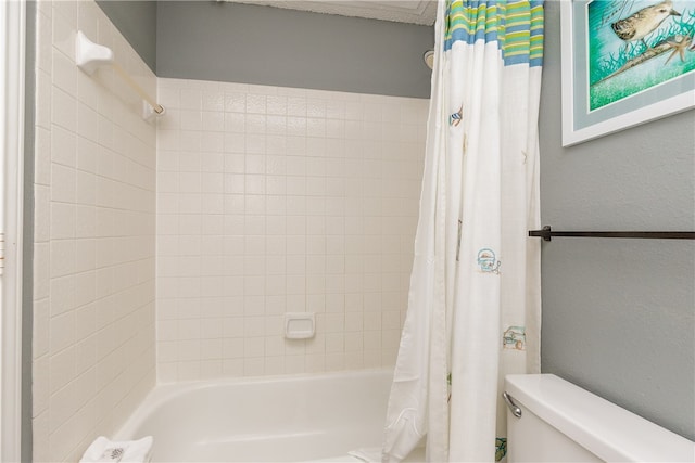 bathroom featuring shower / tub combo with curtain and toilet