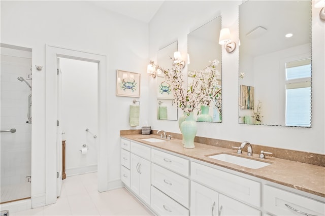 bathroom with walk in shower, vanity, and tile patterned floors