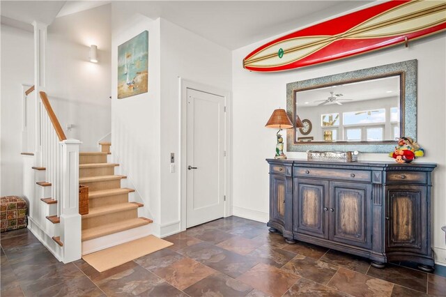 3700 Island Moorings Pkwy Unit 20, Port Aransas, TX 78373 - entryway featuring stairway, baseboards, and dark stone finish flooring