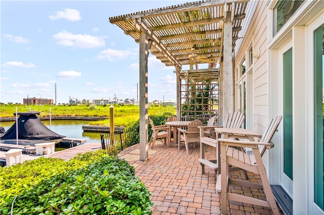 view of patio featuring a dock, a water view, and a pergola