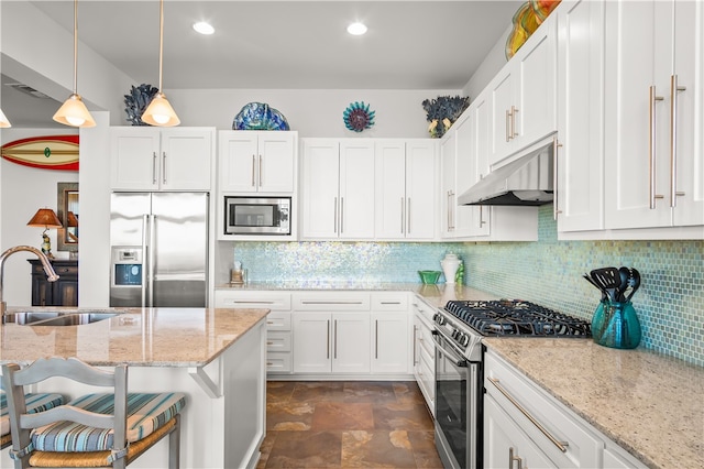 kitchen with white cabinetry, sink, a kitchen breakfast bar, and stainless steel appliances