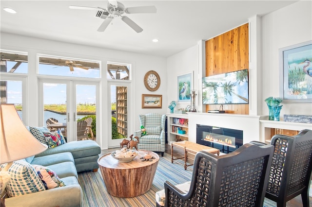 living area featuring hardwood / wood-style flooring and ceiling fan