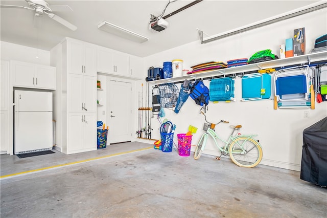 garage featuring a garage door opener and white fridge