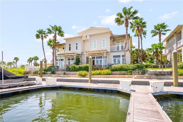 back of house featuring a water view and a balcony