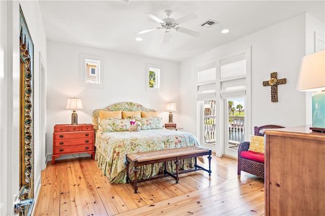 bedroom with light wood-type flooring, access to outside, multiple windows, and ceiling fan