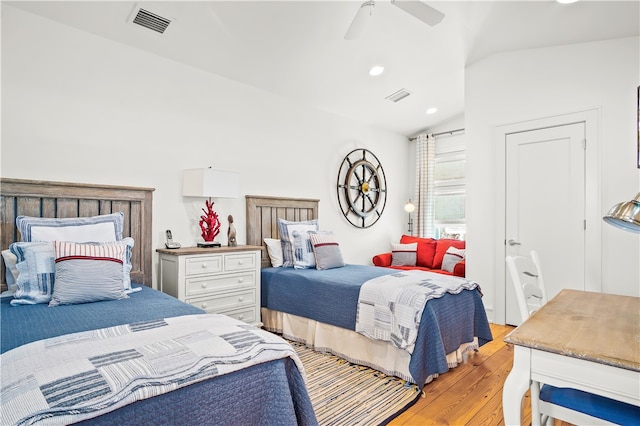 bedroom featuring light wood-type flooring, lofted ceiling, and ceiling fan