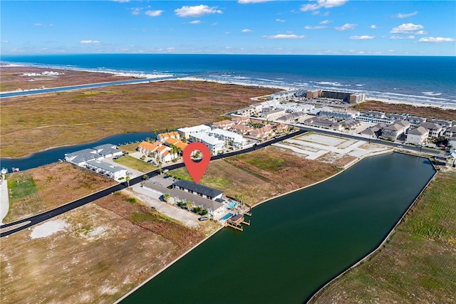 drone / aerial view featuring a water view and a view of the beach