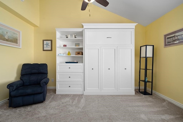 living area with lofted ceiling, light carpet, and ceiling fan