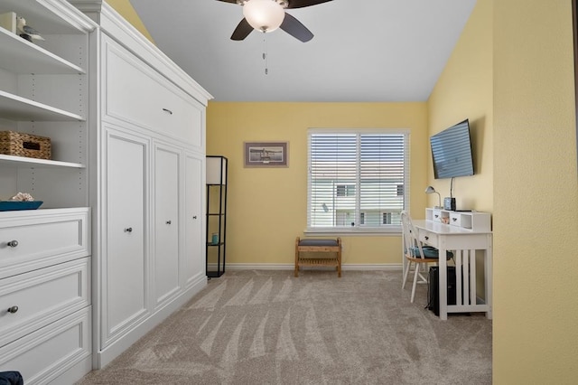 office featuring ceiling fan, light colored carpet, and lofted ceiling