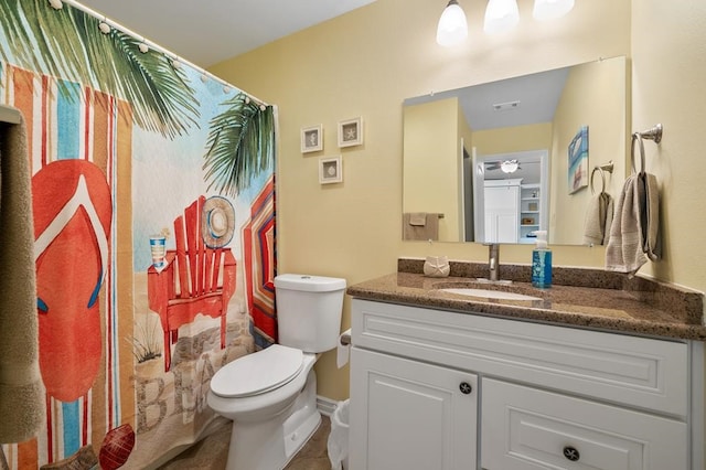 bathroom featuring ceiling fan, vanity, and toilet