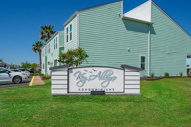 community / neighborhood sign with a lawn