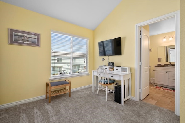 office with light colored carpet, sink, and vaulted ceiling