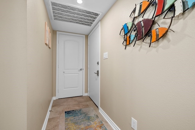 hallway with tile patterned floors