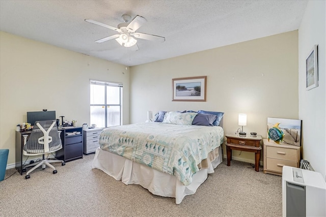 carpeted bedroom featuring a textured ceiling and ceiling fan