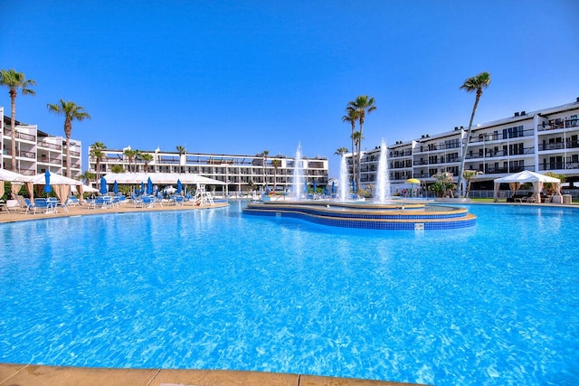 view of swimming pool with pool water feature