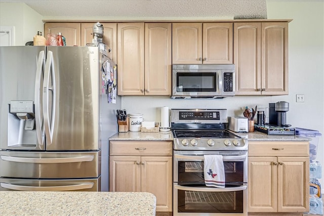 kitchen with light brown cabinets and stainless steel appliances