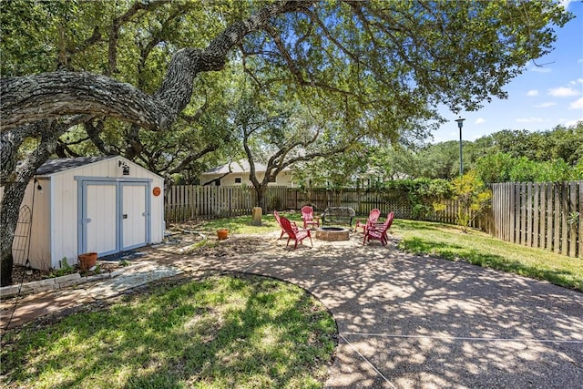 101 Bay Hills Dr, Rockport, TX 78382 - fenced backyard featuring a fire pit, a storage shed, and a patio