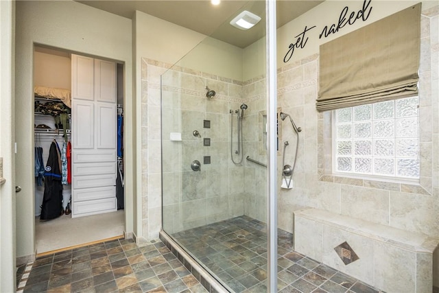 101 Bay Hills Dr, Rockport, TX 78382 - full bath featuring a shower stall, a spacious closet, and stone finish floors
