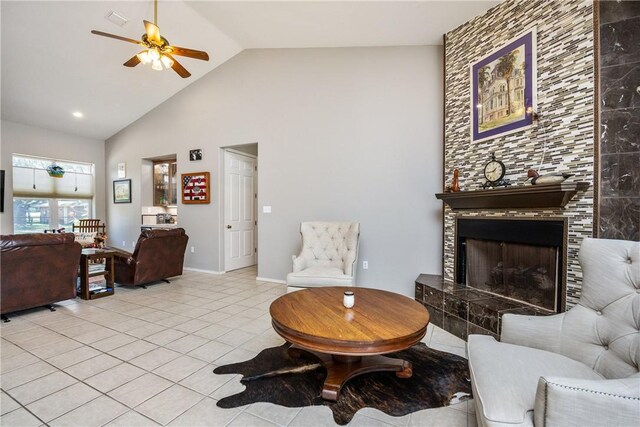 101 Bay Hills Dr, Rockport, TX 78382 - living room featuring a ceiling fan, light tile patterned floors, high vaulted ceiling, and a tiled fireplace