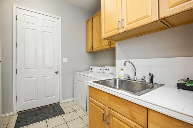 101 Bay Hills Dr, Rockport, TX 78382 - laundry room with washing machine and clothes dryer, cabinet space, and light tile patterned floors