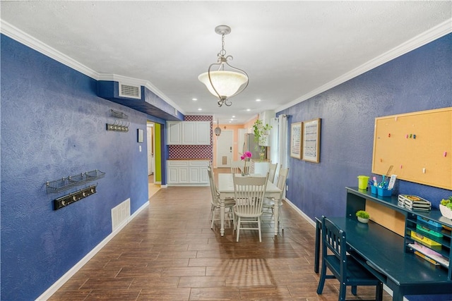 101 Llano Dr, Portland, TX 78374 - dining area with wood finished floors, a textured wall, crown molding, baseboards, and recessed lighting