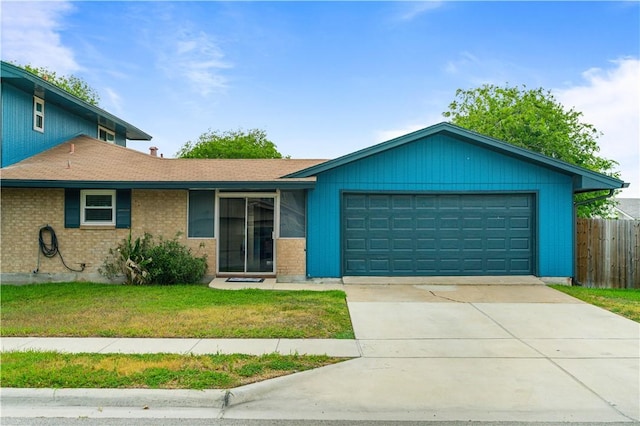 101 Llano Dr, Portland, TX 78374 - single story home with an attached garage, driveway, brick siding, and roof with shingles